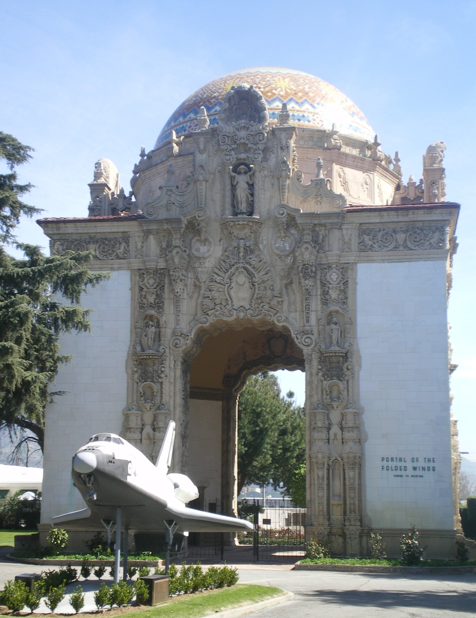 The Portal of the Folded Wings shrine to aviation in Burbank, with a space shuttle model in front